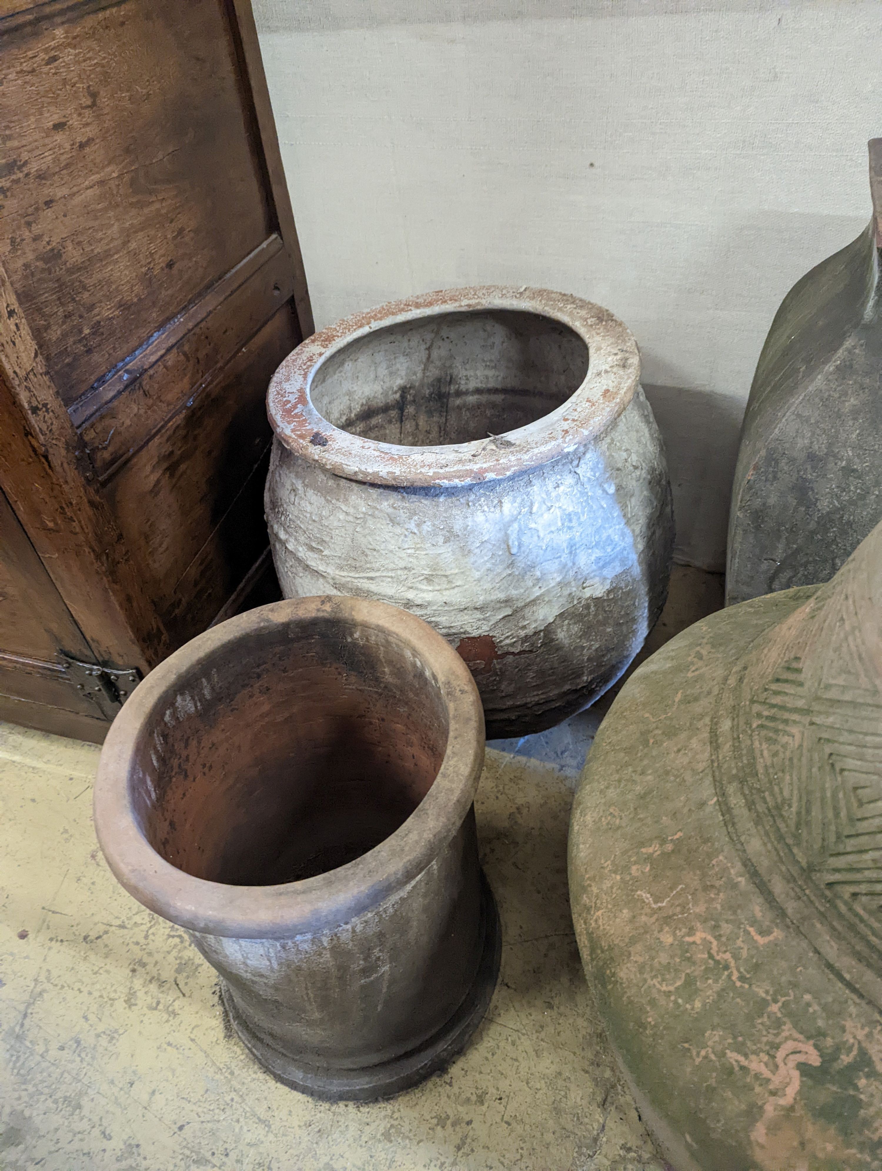 A large incised terracotta garden urn, height 72cm together with three other large earthenware garden urns
